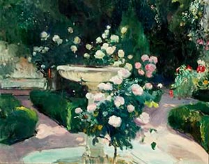 A stone rose fountain surrounded by colourful blooms in the tranquil garden at Casa Sorolla